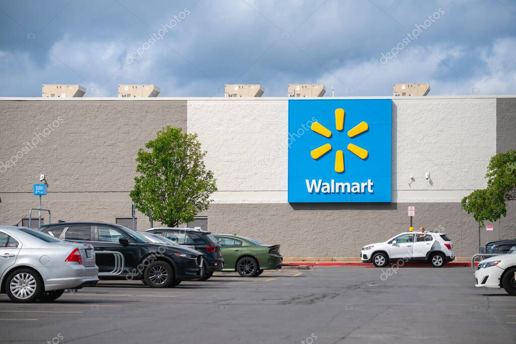 Rome, NY - Jul 20, 2025: Close-up view of Walmart Supercenter parking lot and huge mural signage of Walmart logo, Walmart is on the number on the list of The Fortune 500