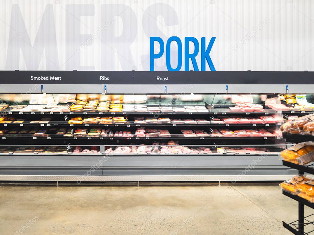 Rome, NY - Jul 20, 2025: Ultra-wide view of Walmart Supercenter pork meat section, Walmart is on the number on the list of The Fortune 500