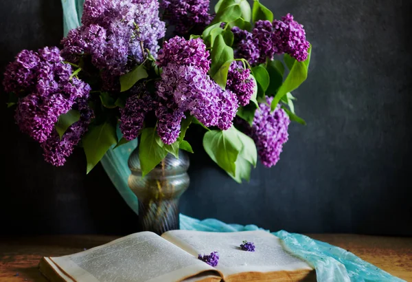 still life with lilac flowers and books