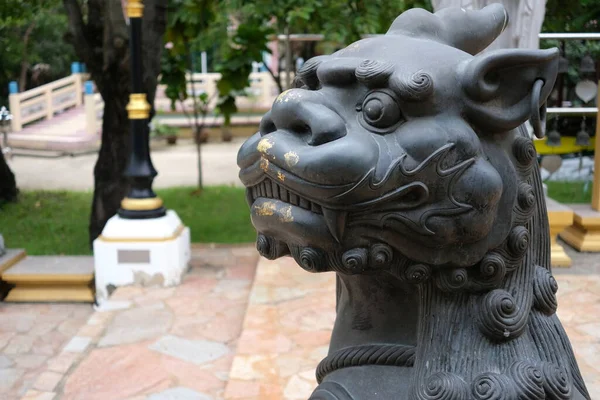 Chinese Bronze Lion in front of Temple.