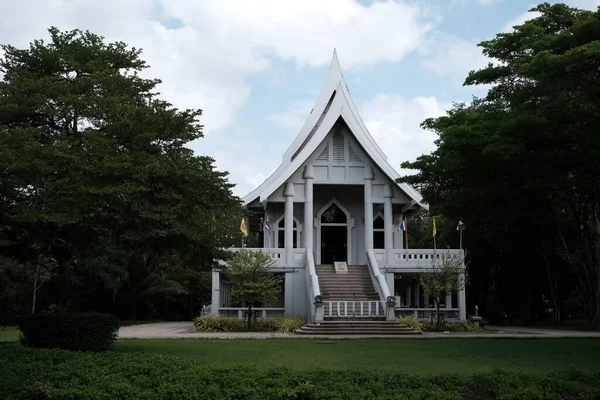 stock image NAKHON PATHOM, THAILAND - JUNE 04, 2022: White Church in the Park at Wat Nyanavesakavan Temple where is a famous Temple in Thailand.