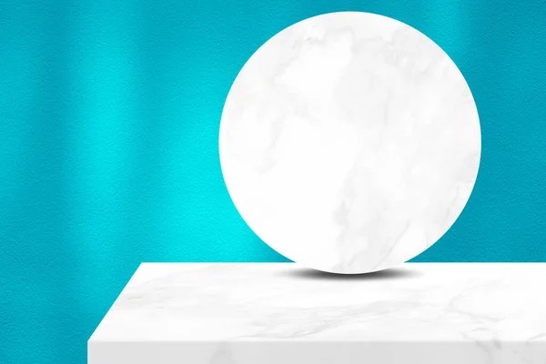 Minimal White Marble Table Corner and Circle Marble Partition with Light Beam on Blue Concrete Wall Texture Background, Suitable for Cosmetic Product Presentation Backdrop, Display, and Mock up.