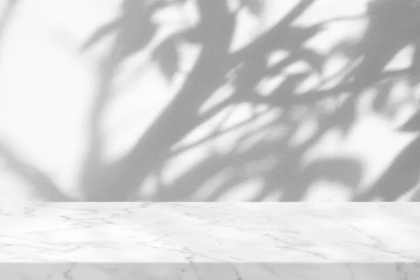White Marble Table with Tree Shadow in the park on Concrete Wall Texture Background, Suitable for Product Presentation Backdrop, Display, and Mock up.