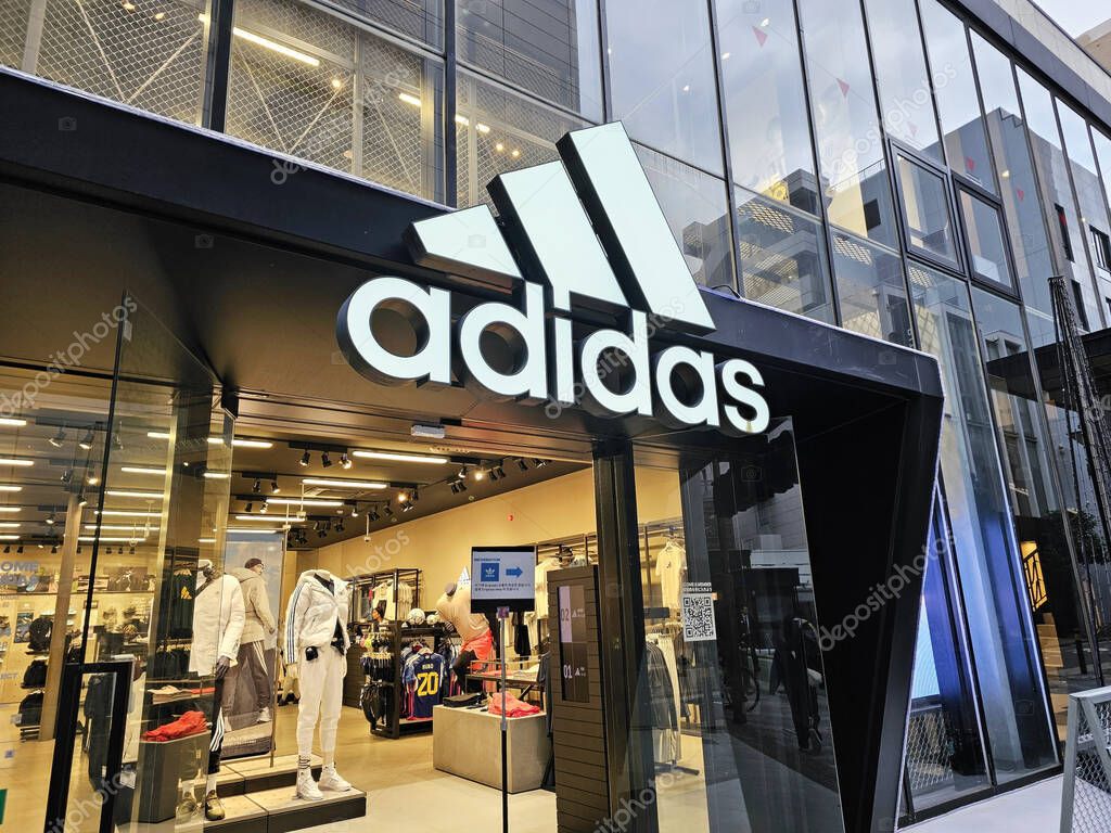 FUKUOKA, JAPAN - NOVEMBER 13, 2023: Adidas sign in front of shop at Tenjin. It is a German athletic apparel and footwear corporation that was founded in August 18, 1949.
