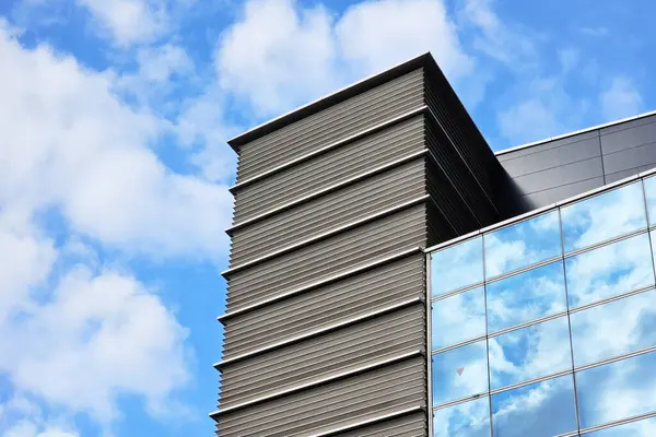 Minimal Building with White Cloud and Blue Sky Background.