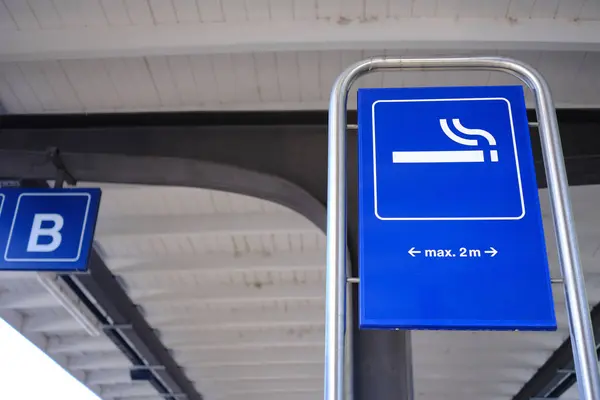 Smoking zone sign in public area.