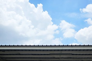 Mavi Gökyüzü ve Beyaz Bulutlar Bir Çatı Çizgisi Üzerinde.