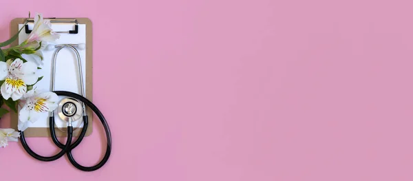 Horizontal banner, medics day, doctors day. Medical equipment above pastel pink background. Space for text.