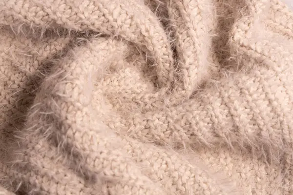 Beyaz örgü kumaş. Ev yapımı kaşmir yün süveterin yumuşak dokusu