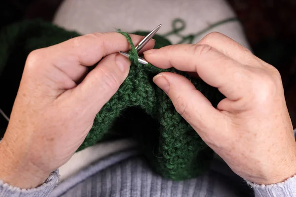 stock image Woman knits with knitting needles from yarn. Concept of cozy knitting at home