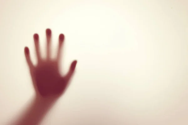 stock image Blurred shadow of hand behind glass, concept of nightmare, crazy people