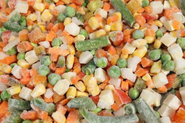 Mexican Mix of frozen vegetable containing carrots, peas, corn, background, texture