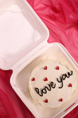 Trendy bento cake delicate biscuit with the inscription love you, a gift for mom or a loved one