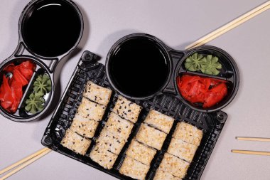 Laid table with sushi, rolls and sauce, japanese food concept