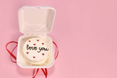 Trendy bento cake delicate biscuit with the inscription love you, a gift for mom or a loved one