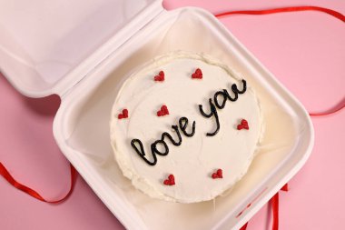 Trendy bento cake delicate biscuit with the inscription love you close-up