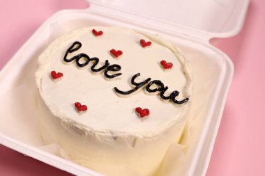 Trendy bento cake delicate biscuit with the inscription love you close-up