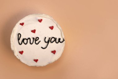 Trendy bento cake delicate biscuit with the inscription love you on a light background