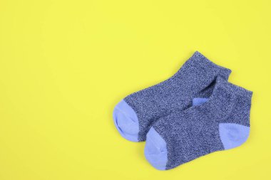 Pair of children's socks on a yellow background