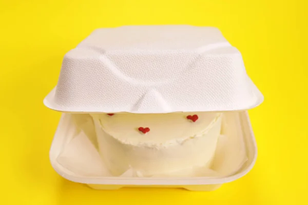 Bento cake in a box on a yellow background. Gift for valentine\'s day, all lovers