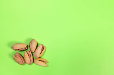 pistachios on a green background close-up macro. copy space for text