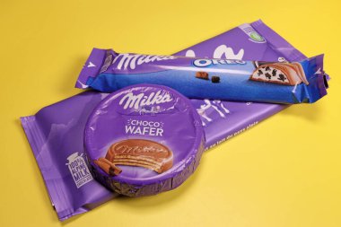 Magdalinovka, Ukraine - February 16, 2022. Milka chocolate products on yellow background
