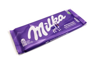 Magdalinovka, Ukraine - February 16, 2022. Milk chocolate Milka. Alpine milk chocolate in wrapper isolated on white background