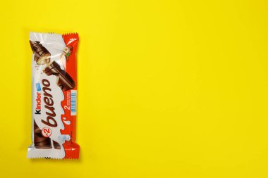 Magdalinovka, Ukraine - February 16, 2022. Kinder bueno chocolate candy bar by Ferrero on a yellow background