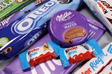 Magdalinovka, Ukraine - February 16, 2022. Chocolate bars and sweets from famous brands Milka, Kinder
