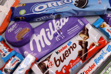 Magdalinovka, Ukraine - February 16, 2022. Chocolate bars and sweets from famous brands Milka, Kinder