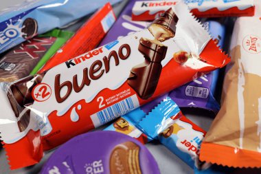 Magdalinovka, Ukraine - February 16, 2022. Chocolate bars and sweets from famous brands Milka, Kinder