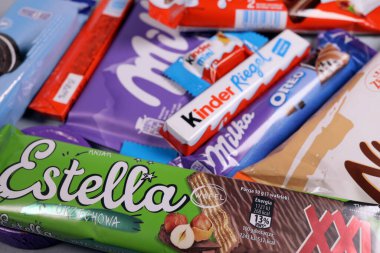 Magdalinovka, Ukraine - February 16, 2022. Chocolate bars and sweets from famous brands Milka, Kinder