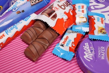 Magdalinovka, Ukraine - February 16, 2022. Chocolate bars and sweets from famous brands Milka, Kinder