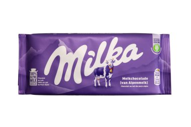 Magdalinovka, Ukraine - February 16, 2022. Milk chocolate Milka. Alpine milk chocolate in wrapper isolated on white background