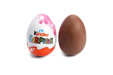 Magdalinovka, Ukraine - March 4, 2023. Kinder surprise chocolate egg by Ferrero in foil and without packaging clipart