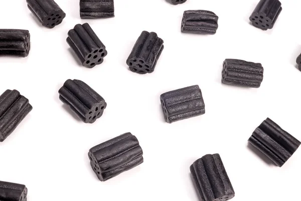 Stock image Pattern of black liquorice sweets on a white background