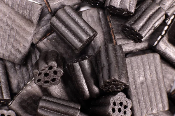Natural black licorice candies close up