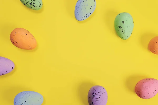 stock image Easter frame made of colored decorative eggs on a yellow background