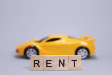 Oyuncak araba ve kelime tahtadan harflerle kiralanmış.