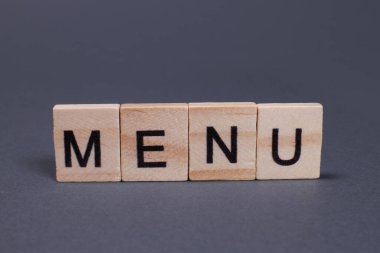 Gri arkaplandaki tahta harflerden menü kelimesi