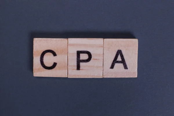 stock image CPA, Certified Public Accountant from wooden letters on a gray background