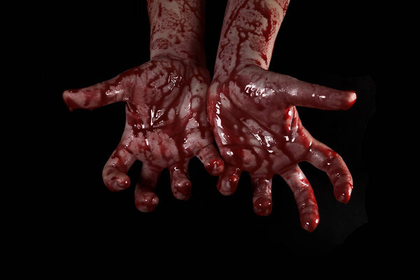 Raised bloody creepy hands on a black background, the concept of murder, nightmares, Halloween