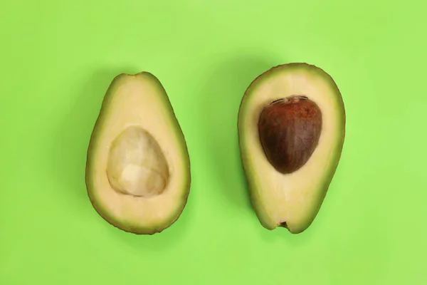 stock image Sliced avocado on a green background, the concept of weight loss, proper nutrition