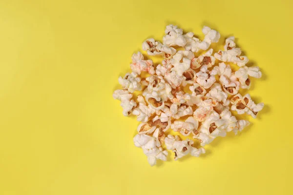 popcorn on yellow background, movie snacks. copy space for text