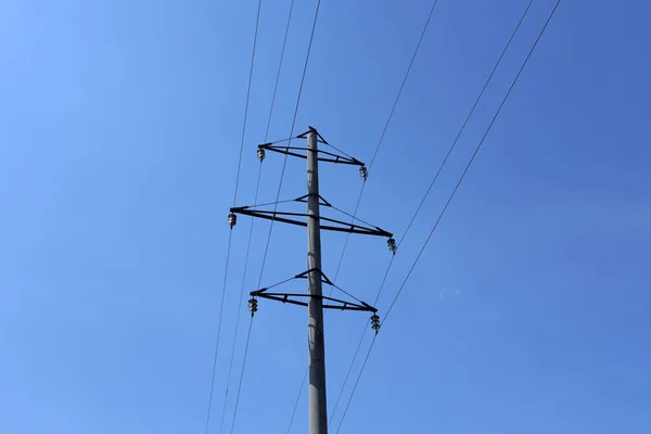 High voltage power line against the blue sky