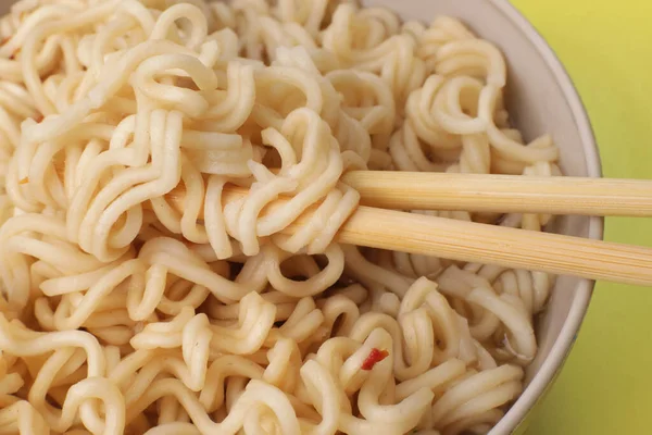 stock image Cooked instant vermicelli with spices and chopsticks close-up