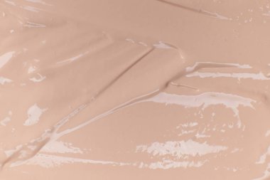 Bej kozmetik fondöten kremi arka planı, doku