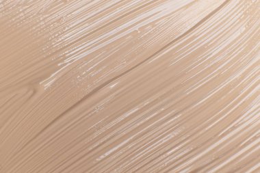 Bej kozmetik fondöten kremi arka planı, doku