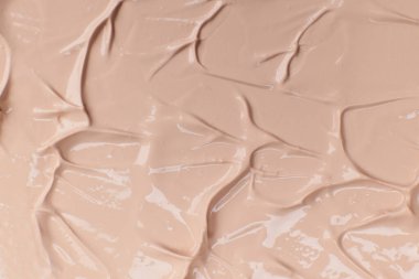 Bej kozmetik fondöten kremi arka planı, doku