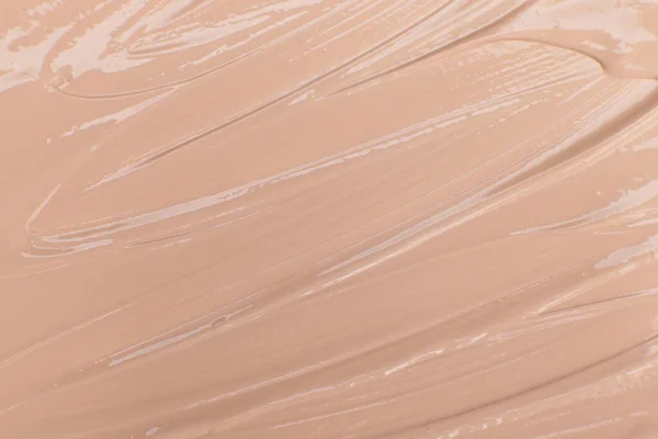 Beige cosmetic foundation cream background, texture